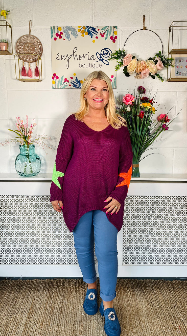 Plum Loose fitting free size jumper with star detail on both sleeves and back worn with denim magic trousers and Blue loafers
