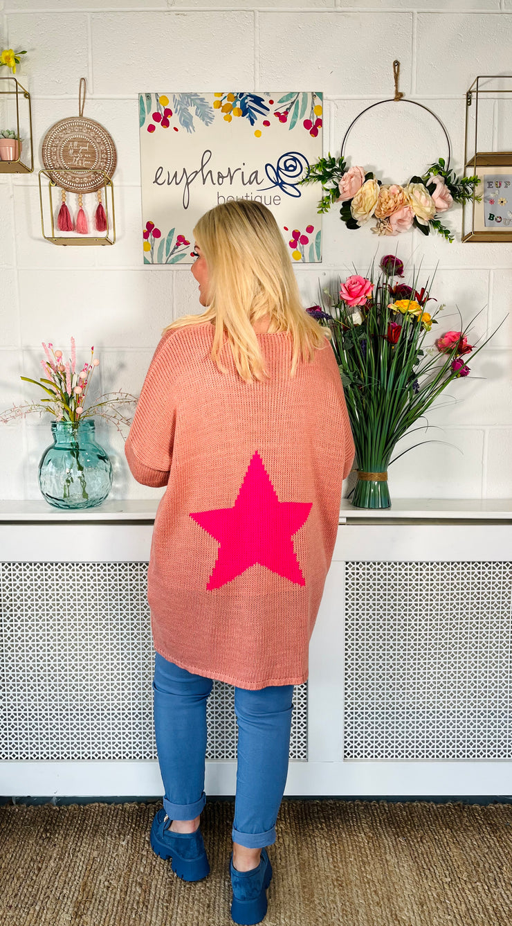 Antique pink Loose fitting free size jumper with star detail on both sleeves and back worn with denim magic trousers and Blue loafers