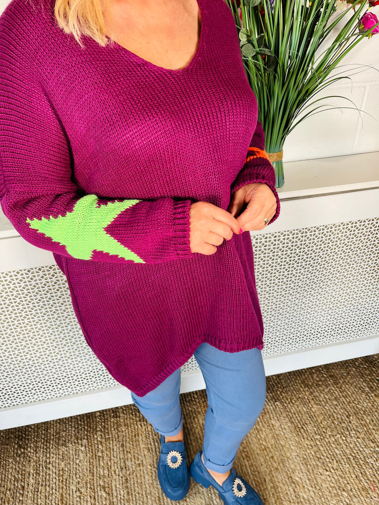 Plum Loose fitting free size jumper with star detail on both sleeves and back worn with denim magic trousers and Blue loafers
