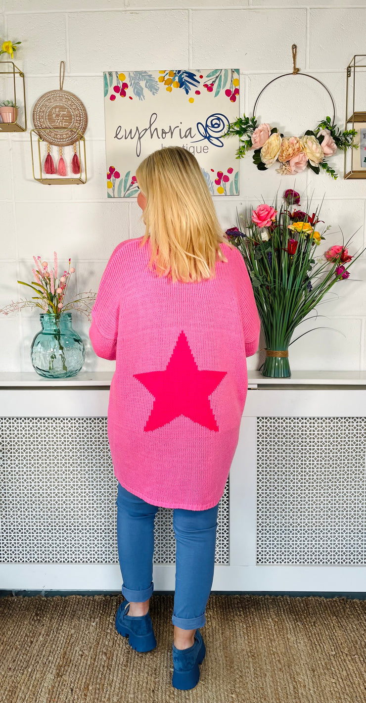 Candy pink Loose fitting free size jumper with star detail on both sleeves and back worn with denim magic trousers and blue loafers