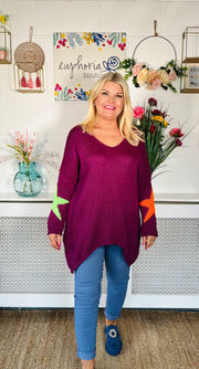 Plum Loose fitting free size jumper with star detail on both sleeves and back worn with denim magic trousers and Blue loafers