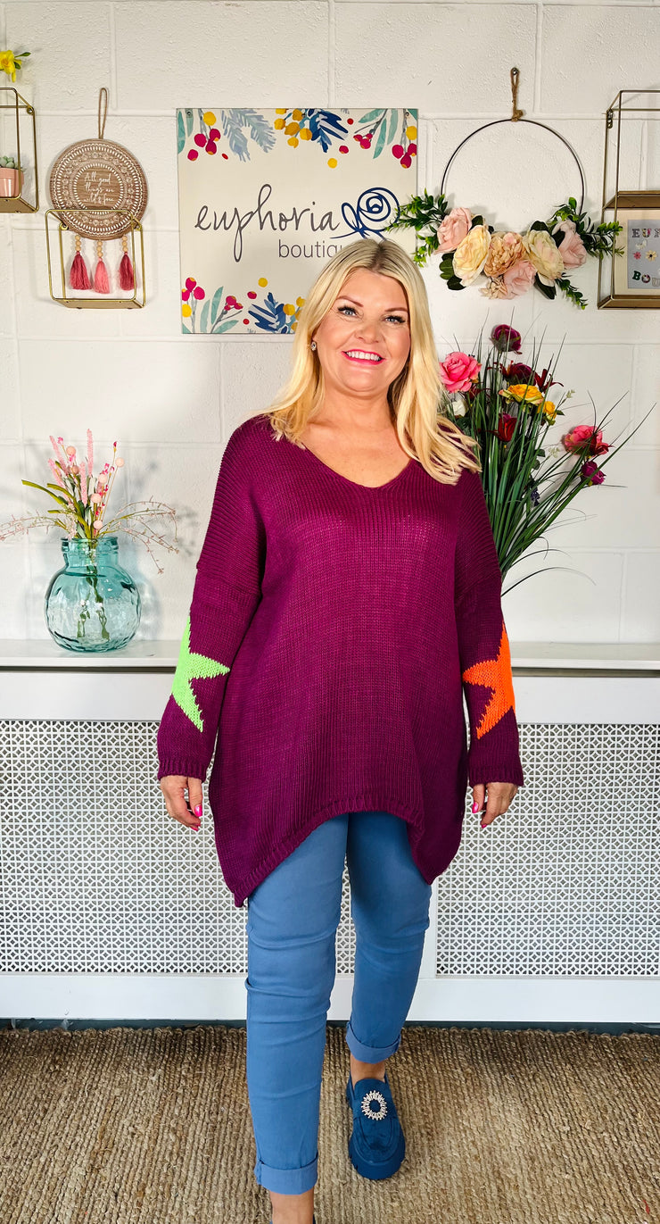 Plum Loose fitting free size jumper with star detail on both sleeves and back worn with denim magic trousers and Blue loafers