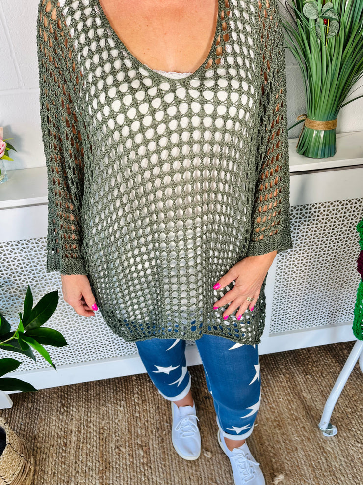 close up of Khaki Crochet Over Top Worn with star print denim joggers and white sock trainers