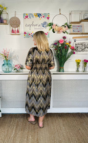 View from back of Metallic Gold patterned free size floaty midi dress with short sleeves