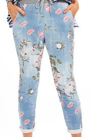 Lady Wearing Light Wash Denim Alice Joggers with Floral Pattern